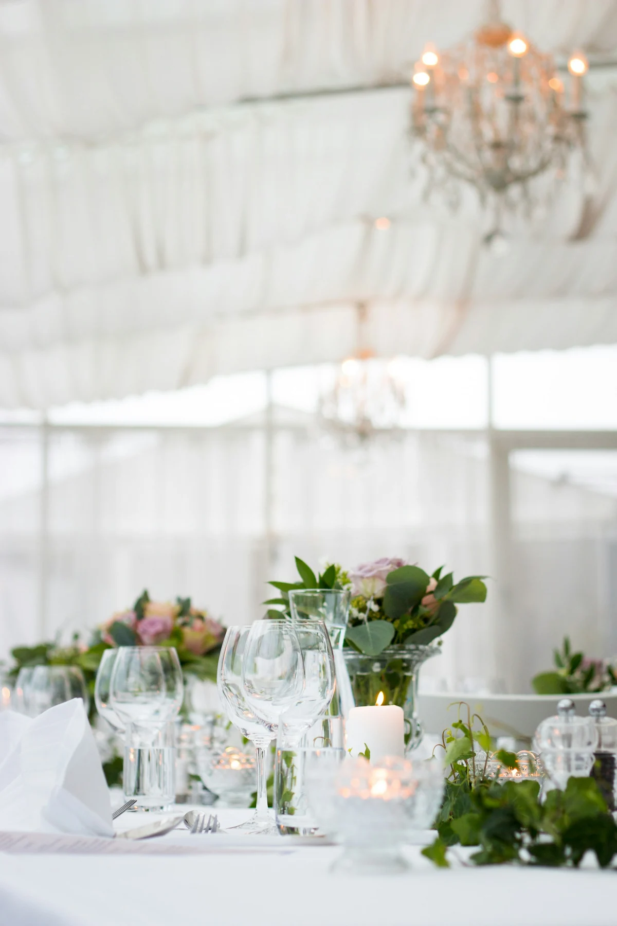A light-filled wedding reception with elegant table settings
